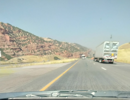 road with red hills at side